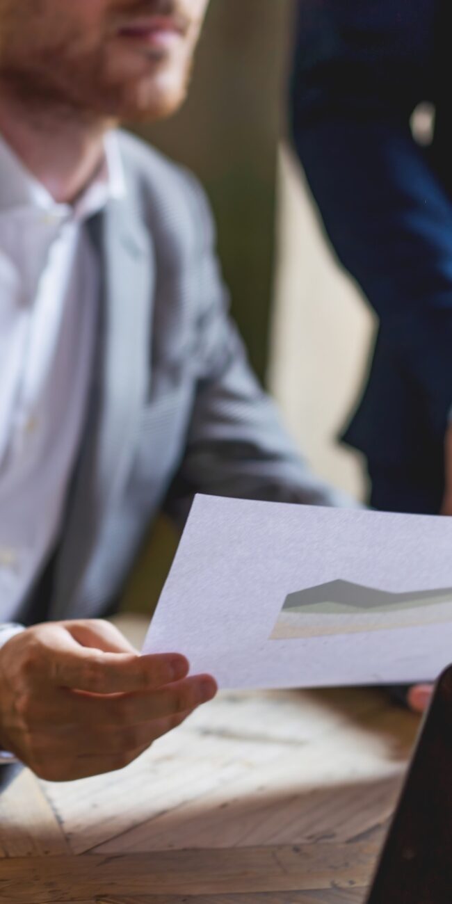 Business Consultation - cropped businessman with a financial document